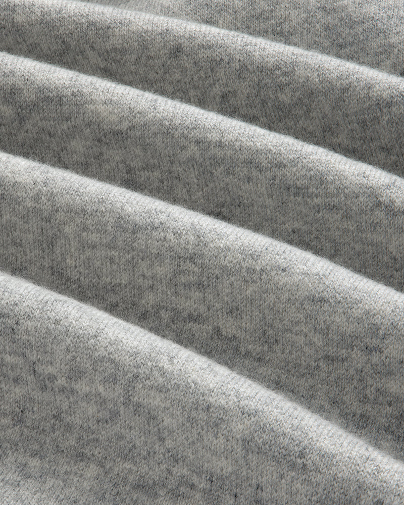 Close-up of folded, soft Pavilion Cashmere Hoodie in heather gray, showing texture and diagonal, parallel folds.
