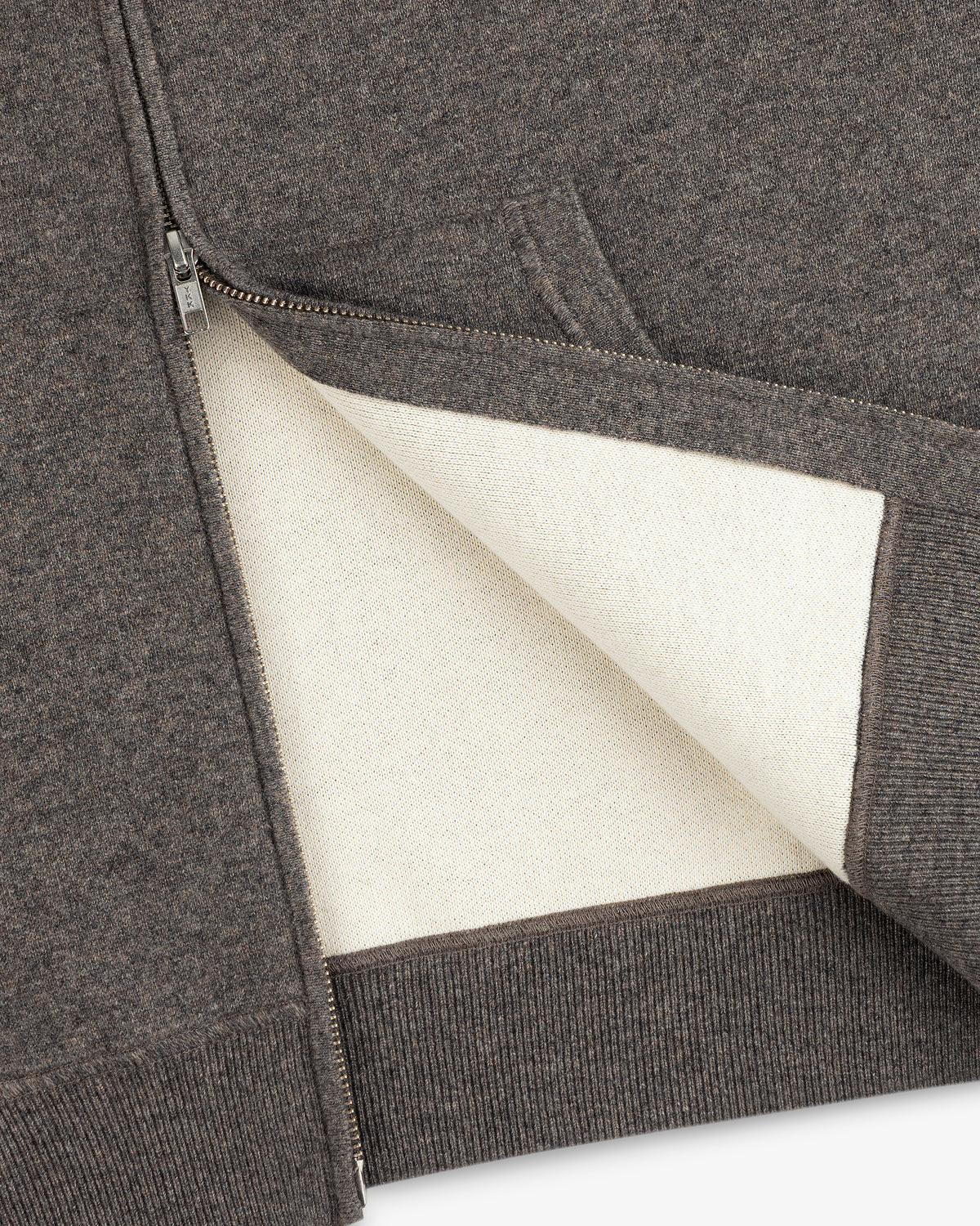 Close-up of the Full-Zip Pavilion Cashmere Hoodie with a soft white lining and ribbed hem.
