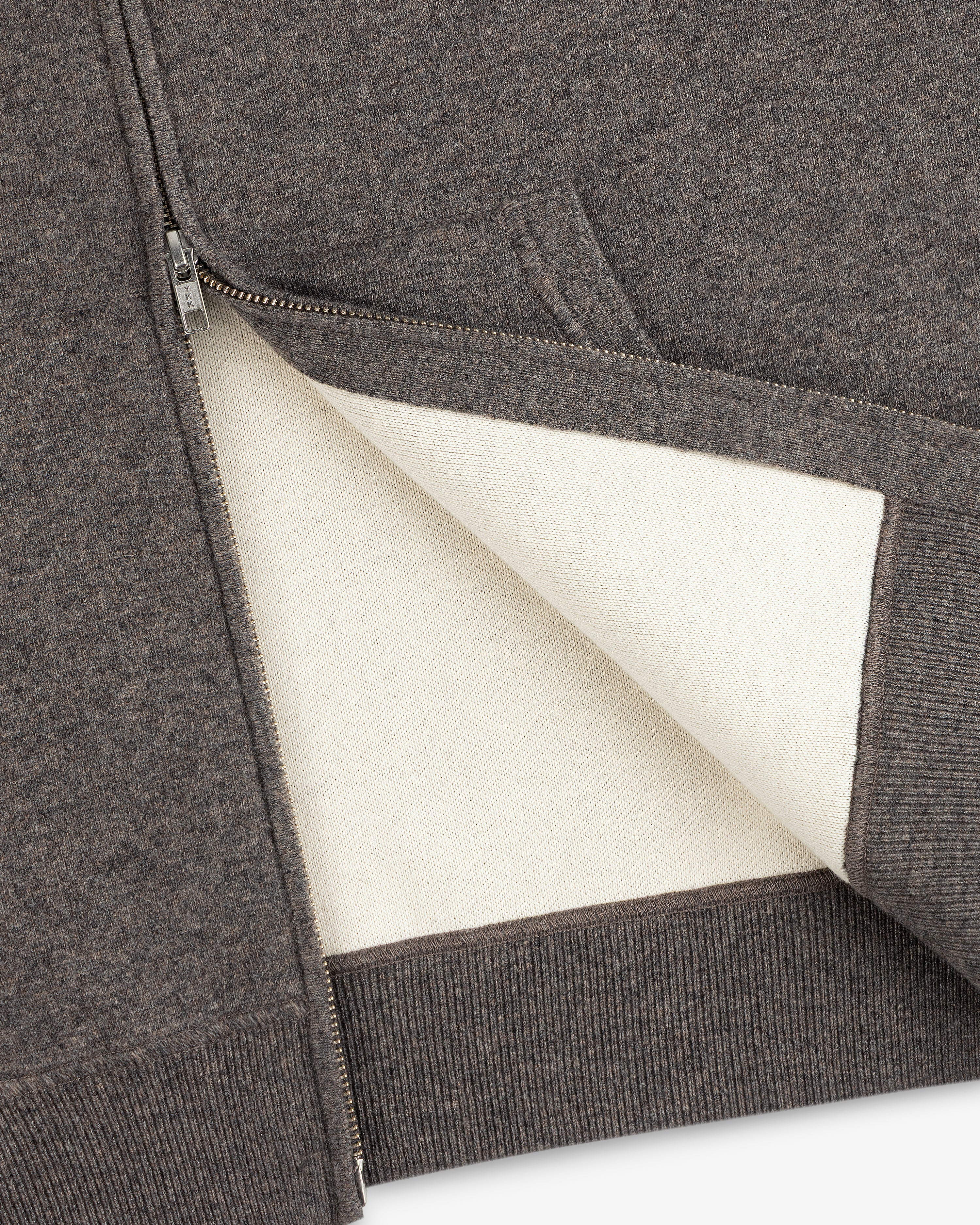 Close-up of the Full-Zip Pavilion Cashmere Hoodie with a soft white lining and ribbed hem.