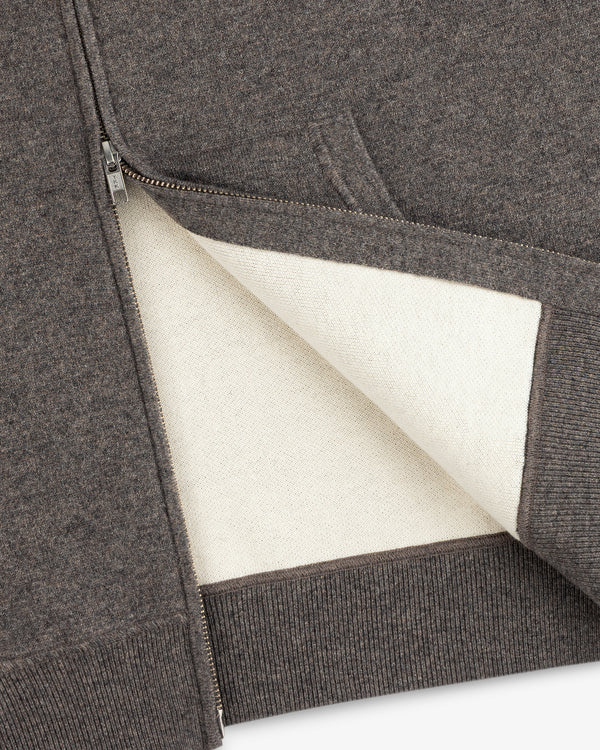 Close-up of the Full-Zip Pavilion Cashmere Hoodie with a soft white lining and ribbed hem.