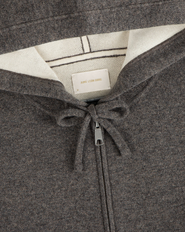 Close-up of a brown Full-Zip Pavilion Cashmere Hoodie with drawstring and visible Aimé Leon Dore label in the collar.