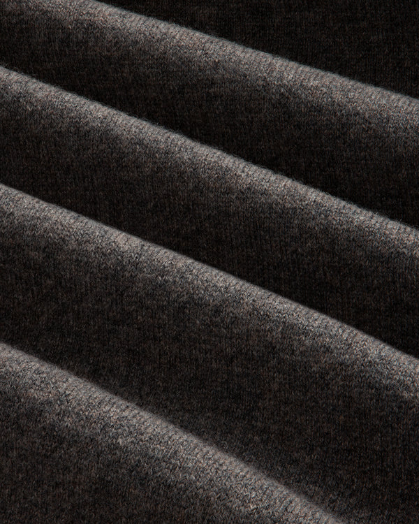 Close-up of Pavilion Cashmere Sweatpant: dark ribbed fabric, soft texture, and deep diagonal folds.