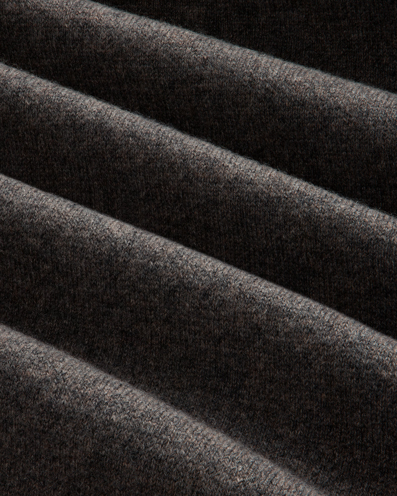Close-up of Pavilion Cashmere Sweatpant: dark ribbed fabric, soft texture, and deep diagonal folds.