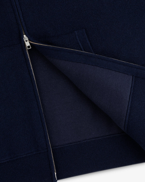 Close-up of the Full-Zip Pavilion Cashmere Hoodie in navy, partially unzipped to reveal inner fabric and stitching.