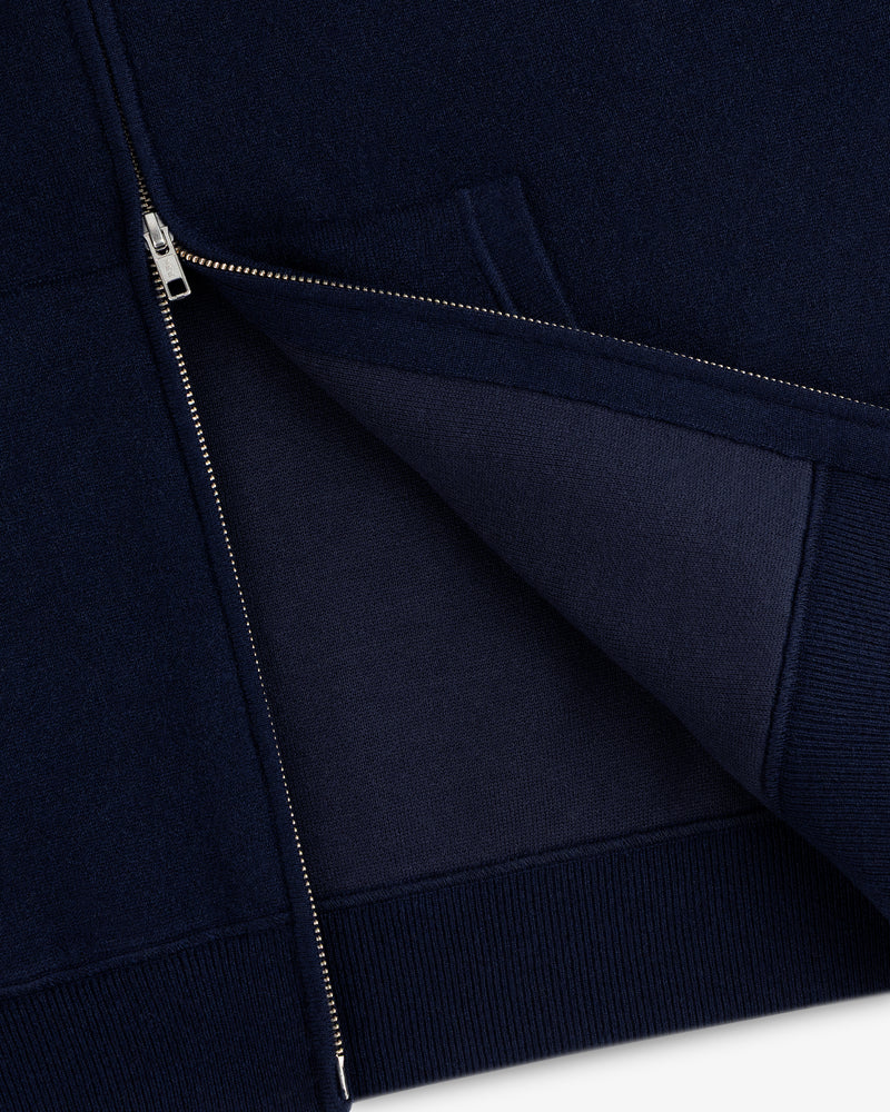 Close-up of the Full-Zip Pavilion Cashmere Hoodie in navy, partially unzipped to reveal inner fabric and stitching.