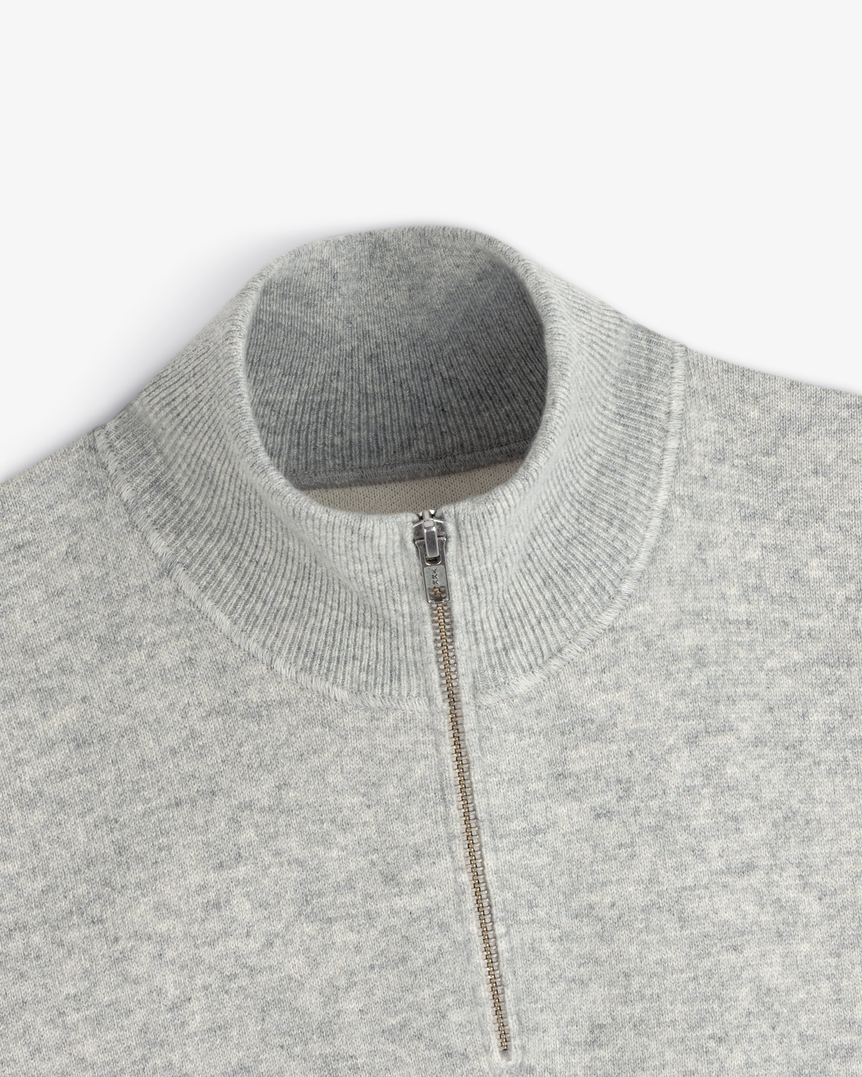 Light gray Pavilion Cashmere Pullover with a ribbed mock neck and quarter-zip silver front.