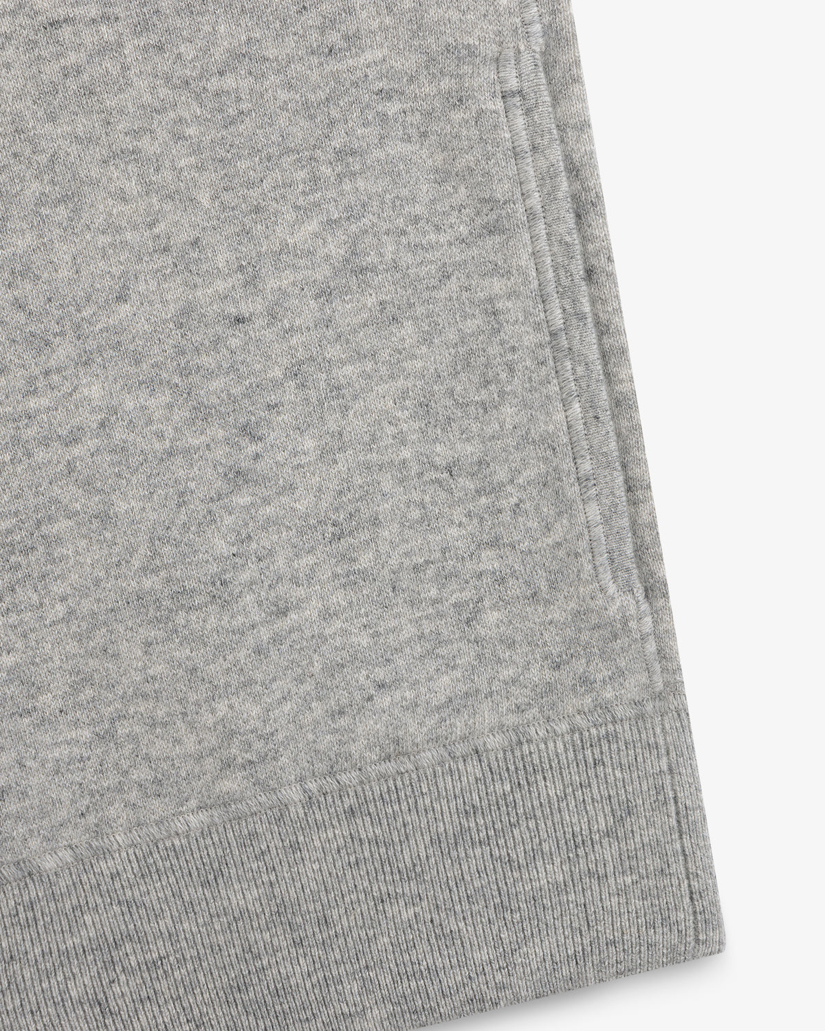 Close-up of a gray Quarter Zip Pavilion Cashmere Pullover, highlighting its pocket and ribbed hem details.