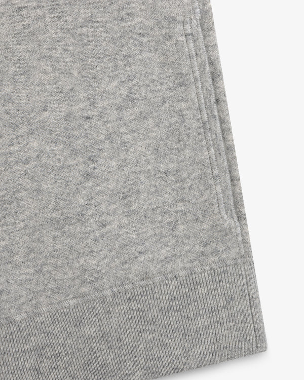 Close-up of a gray Quarter Zip Pavilion Cashmere Pullover, highlighting its pocket and ribbed hem details.