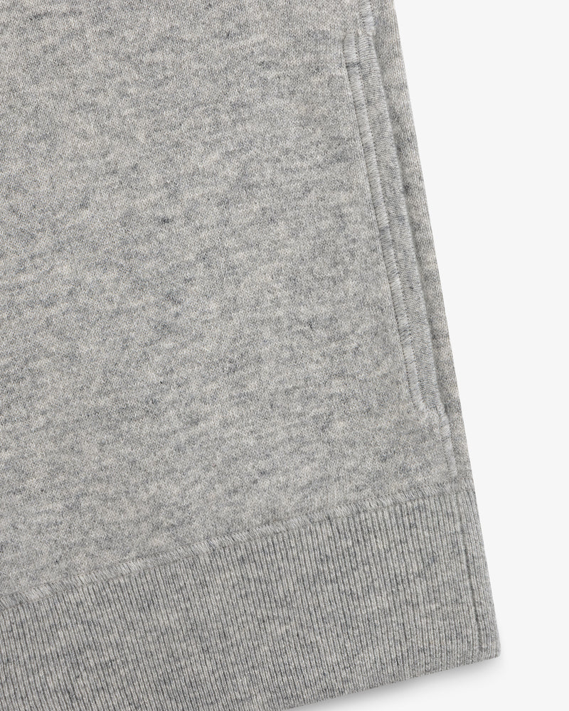 Close-up of a gray Quarter Zip Pavilion Cashmere Pullover, highlighting its pocket and ribbed hem details.