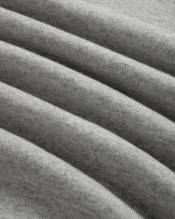 Close-up of the Quarter Zip Pavilion Cashmere Pullover in soft, light gray with gentle, evenly spaced folds.