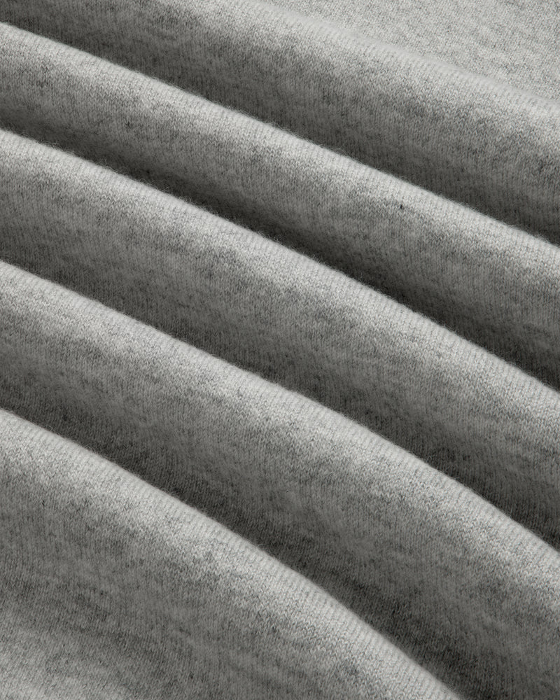 Close-up of the Quarter Zip Pavilion Cashmere Pullover in soft, light gray with gentle, evenly spaced folds.