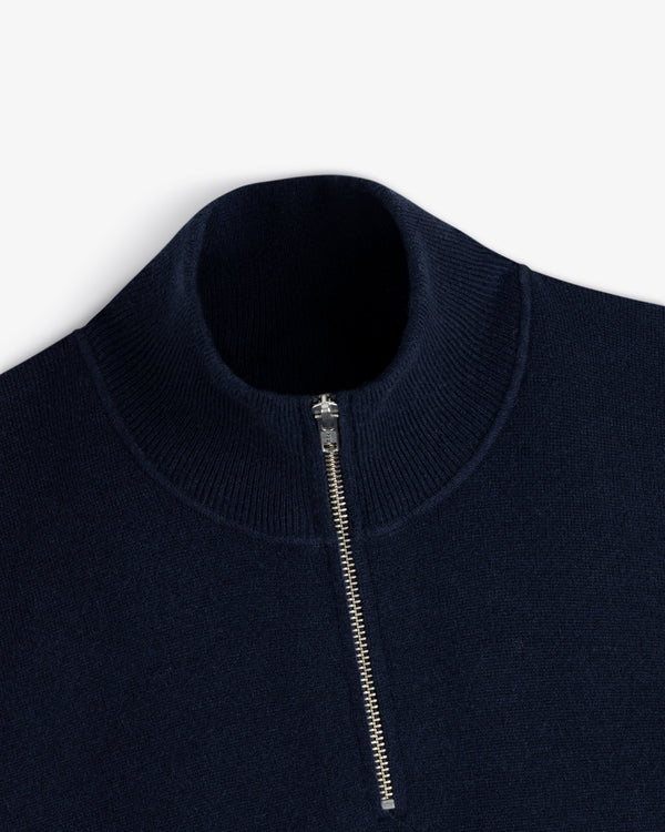 Quarter Zip Pavilion Cashmere Pullover in navy blue with silver half-zip and ribbed high collar, on white background.