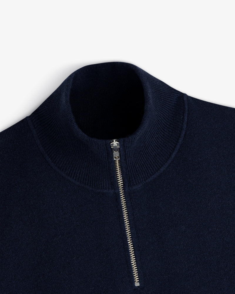 Quarter Zip Pavilion Cashmere Pullover in navy blue with silver half-zip and ribbed high collar, on white background.