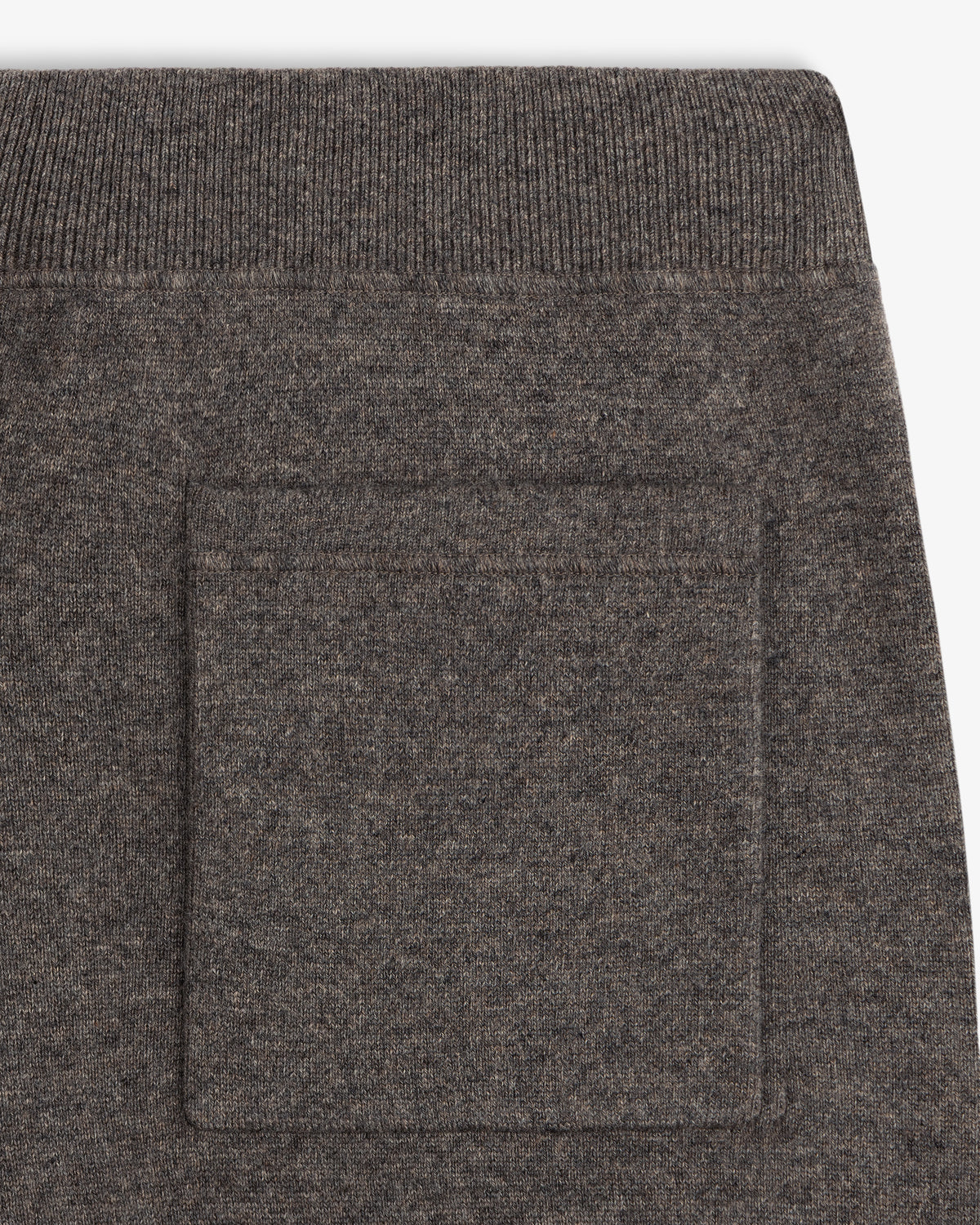 Close-up of Pavilion Cashmere Sweatpant in brown knit with ribbed waistband and square side patch pocket.