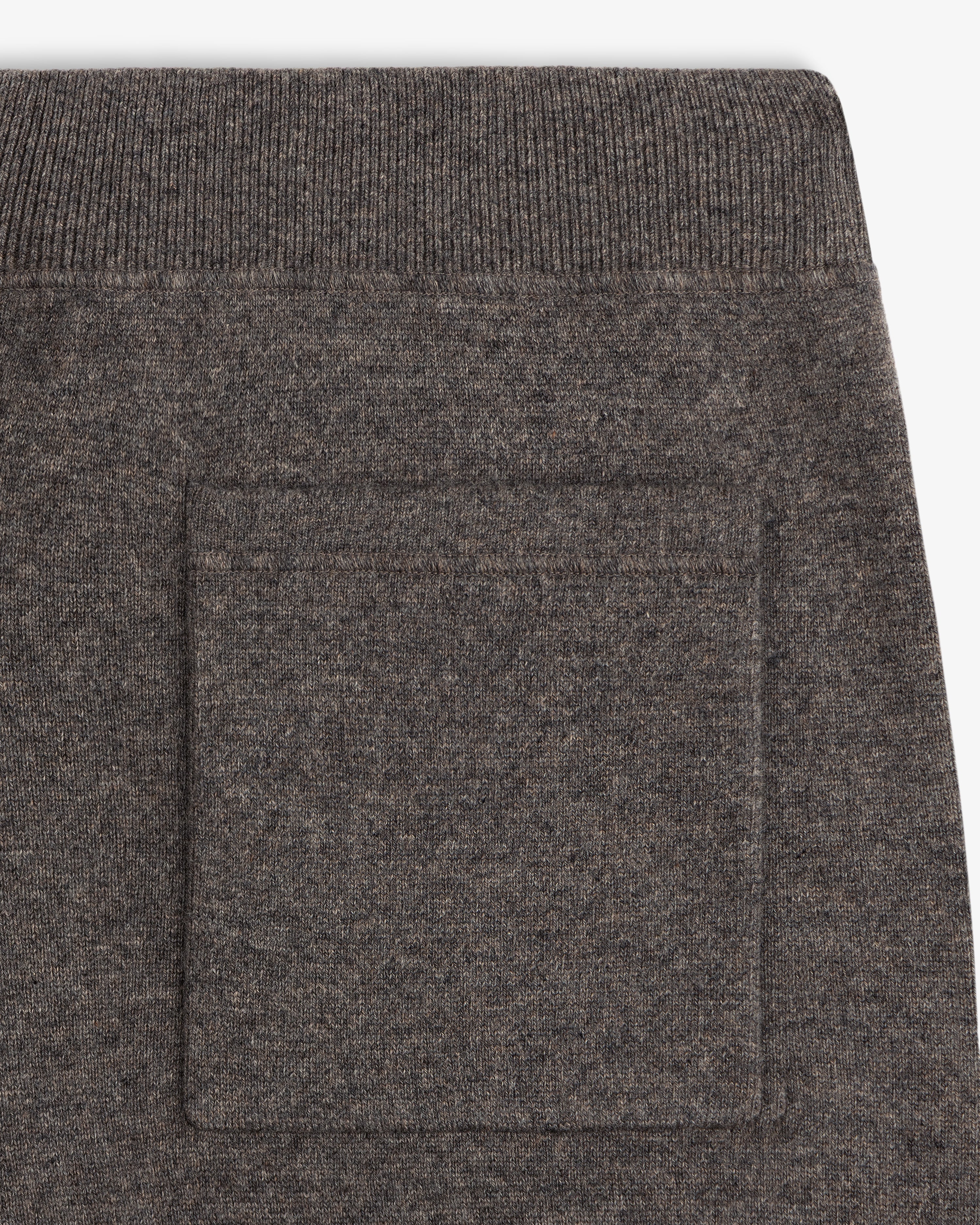 Close-up of Pavilion Cashmere Sweatpant in brown knit with ribbed waistband and square side patch pocket.