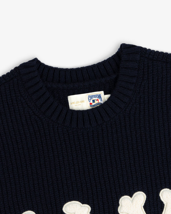 Close-up of the NY Highlanders Ribbed Wool Crewneck Sweater with a white patch detail and branded collar tag.