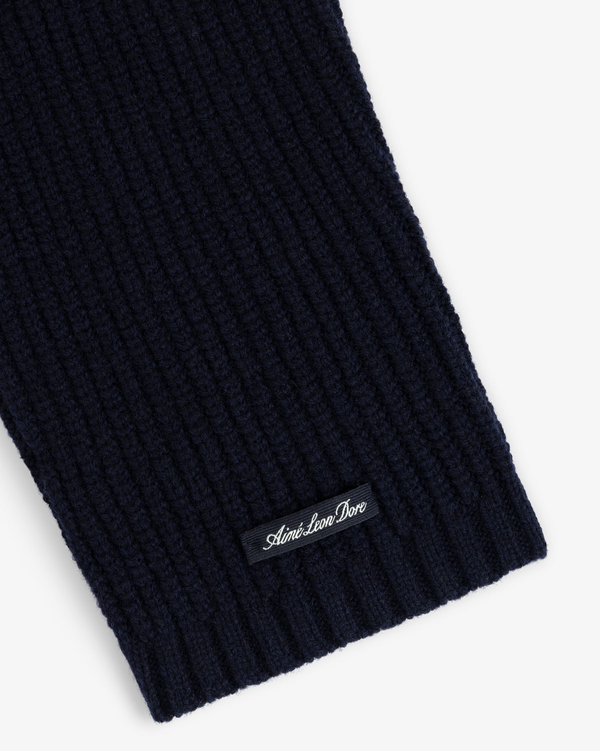 Close-up of the NY Highlanders Ribbed Wool Crewneck Sweater in navy with a small Aime Leon Dore label near the edge.