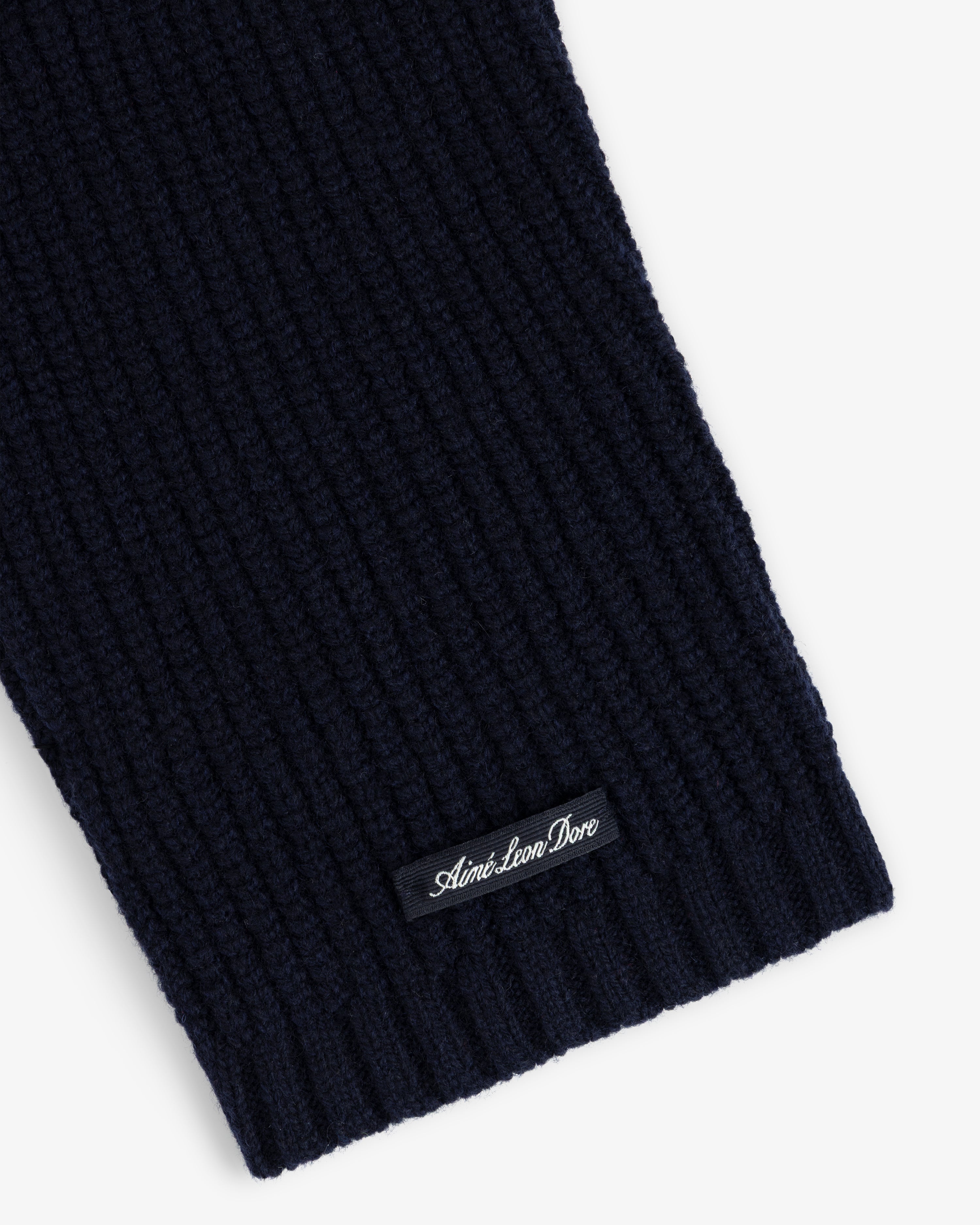 Close-up of the NY Highlanders Ribbed Wool Crewneck Sweater in navy with a small Aime Leon Dore label near the edge.