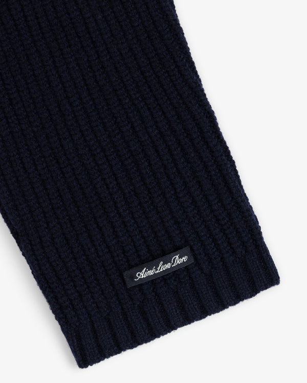 Close-up of the NY Highlanders Ribbed Wool Crewneck Sweater in navy with a small Aime Leon Dore label near the edge.