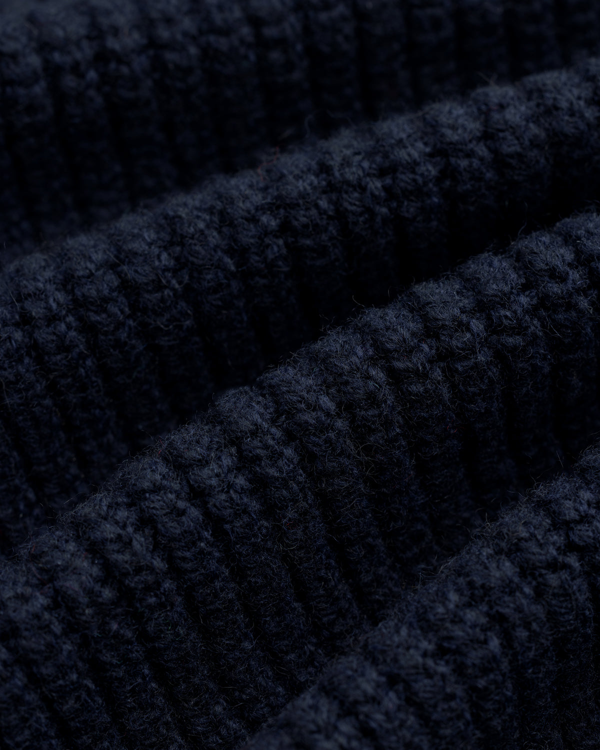 Close-up of NY Highlanders Ribbed Wool Crewneck Sweater in dark blue, highlighting its soft, textured knit rows.
