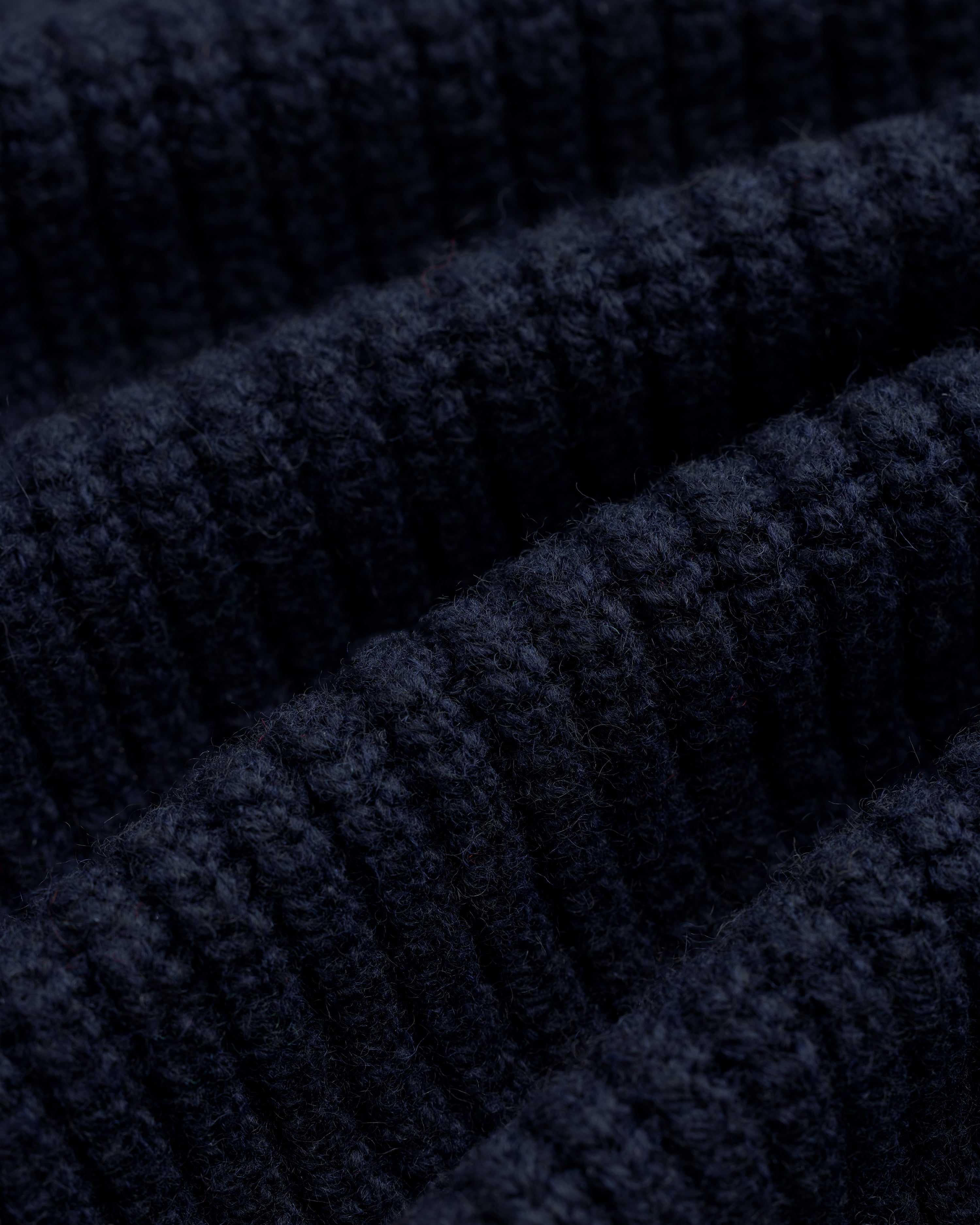 Close-up of NY Highlanders Ribbed Wool Crewneck Sweater in dark blue, highlighting its soft, textured knit rows.