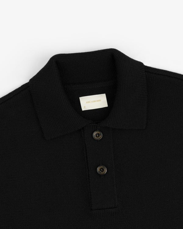 Black Long-Sleeve Merino Polo with a collared neckline and a two-button placket.