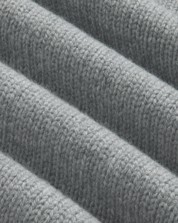 Close-up of a grey Cashmere Crewneck Sweater with folded fabric waves.