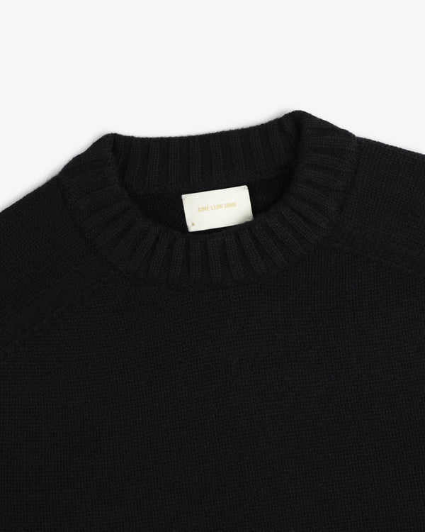 Black Cashmere Crewneck Sweater with a ribbed neckline and interior brand label.