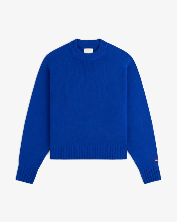 A bright blue Cashmere Crewneck Sweater with long sleeves, ribbed cuffs, and a ribbed hem.