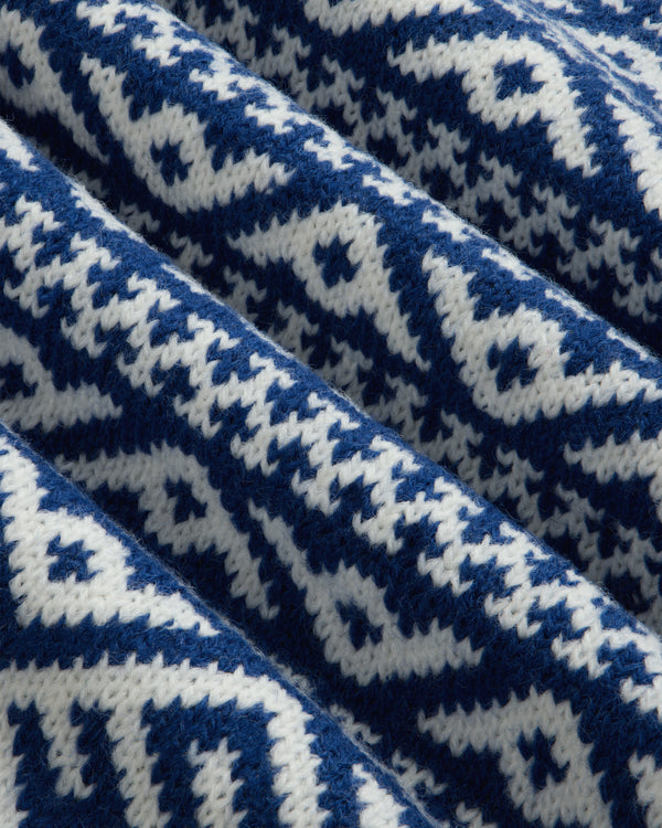 Close-up of the blue and white Poros Jacquard Pullover with a repeating geometric knit pattern.
