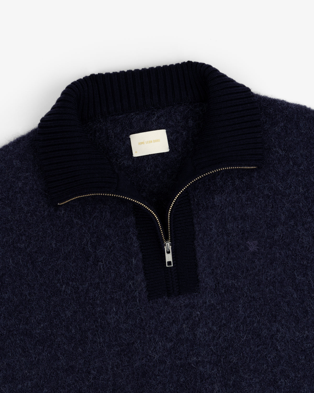 Alpaca Wool Quarter Zip Sweater in navy, fuzzy texture, ribbed collar, gold zipper, shown flat on a white background.