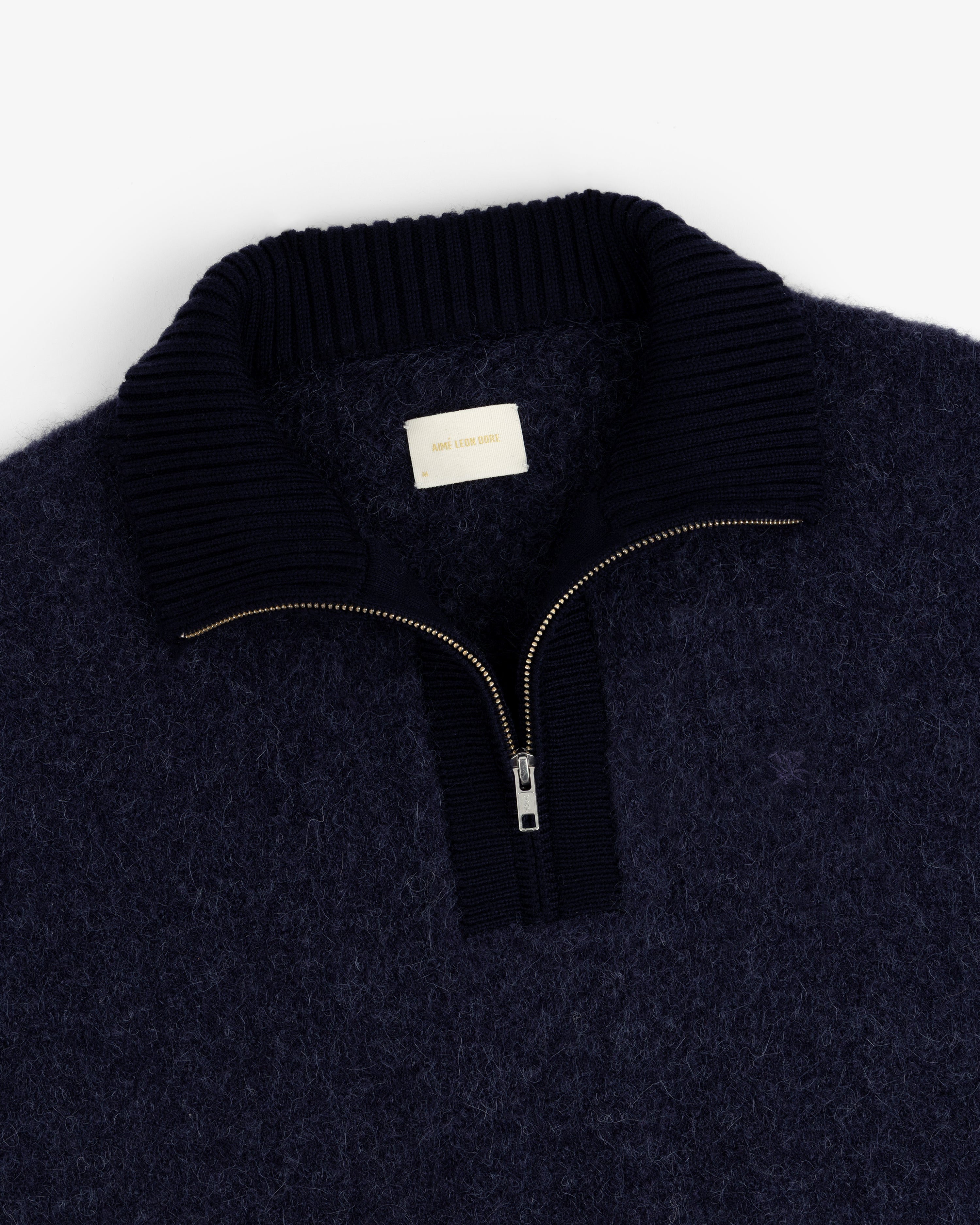 Alpaca Wool Quarter Zip Sweater in navy, fuzzy texture, ribbed collar, gold zipper, shown flat on a white background.