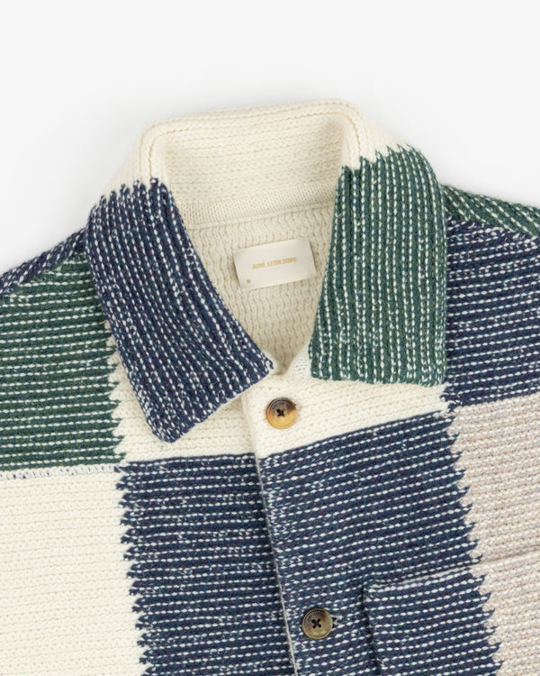 Patchwork Knit Chore Jacket featuring a button-up design in cream, dark green, and navy blue.