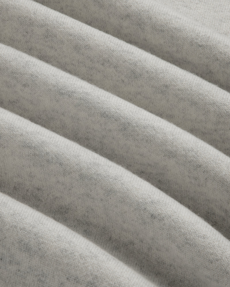 Close-up of Pavilion Cashmere Crewneck Sweatshirt in light gray, showing soft ribbed fabric and horizontal ridges.