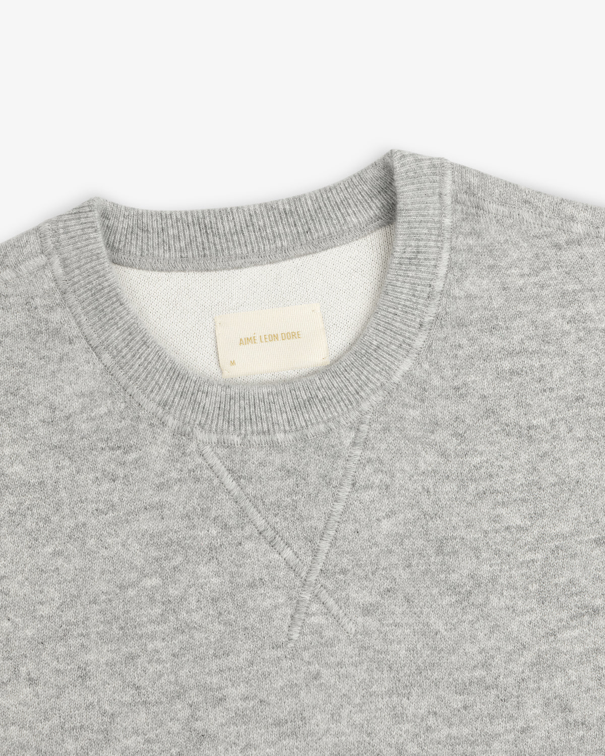 Light gray Pavilion Cashmere Crewneck Sweatshirt with ribbed collar and AIME LEON DORE tag inside the neck.