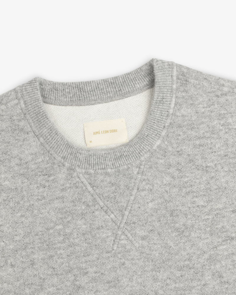 Light gray Pavilion Cashmere Crewneck Sweatshirt with ribbed collar and AIME LEON DORE tag inside the neck.