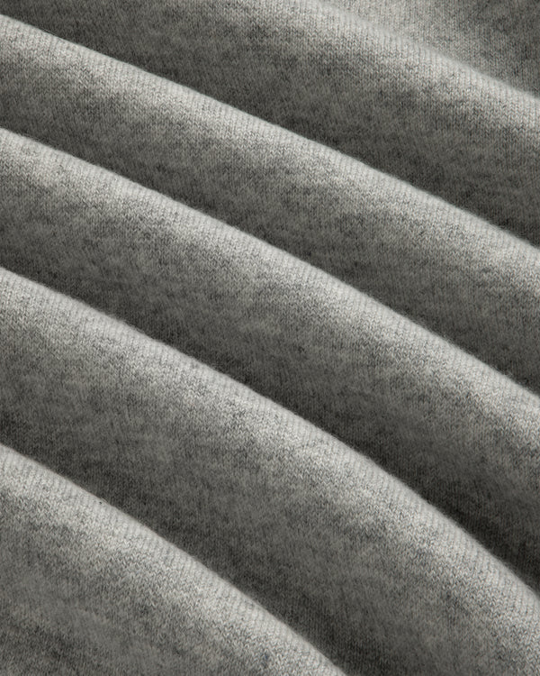 Closeup of Pavilion Cashmere Crewneck Sweatshirt in soft gray ribbed fabric with horizontal folds and texture.