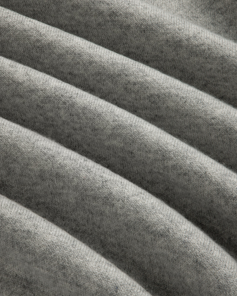 Closeup of Pavilion Cashmere Crewneck Sweatshirt in soft gray ribbed fabric with horizontal folds and texture.