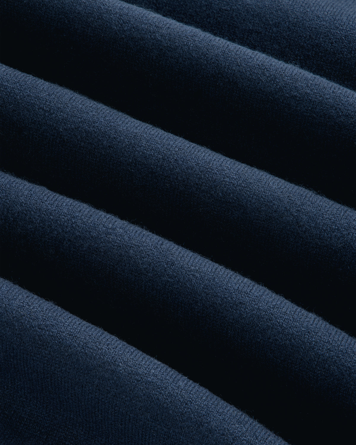 Close-up of Pavilion Cashmere Crewneck Sweatshirt in dark blue, featuring soft ridges and parallel textured lines.
