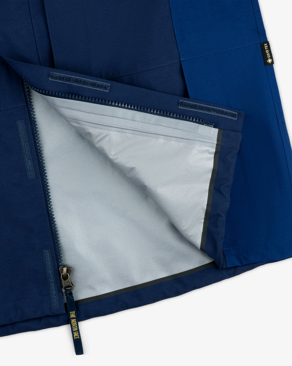 Close-up of ALD/The North Face GORE-TEX 2000 Mountain Jacket’s blue exterior, gray lining, and half-unzipped zipper.