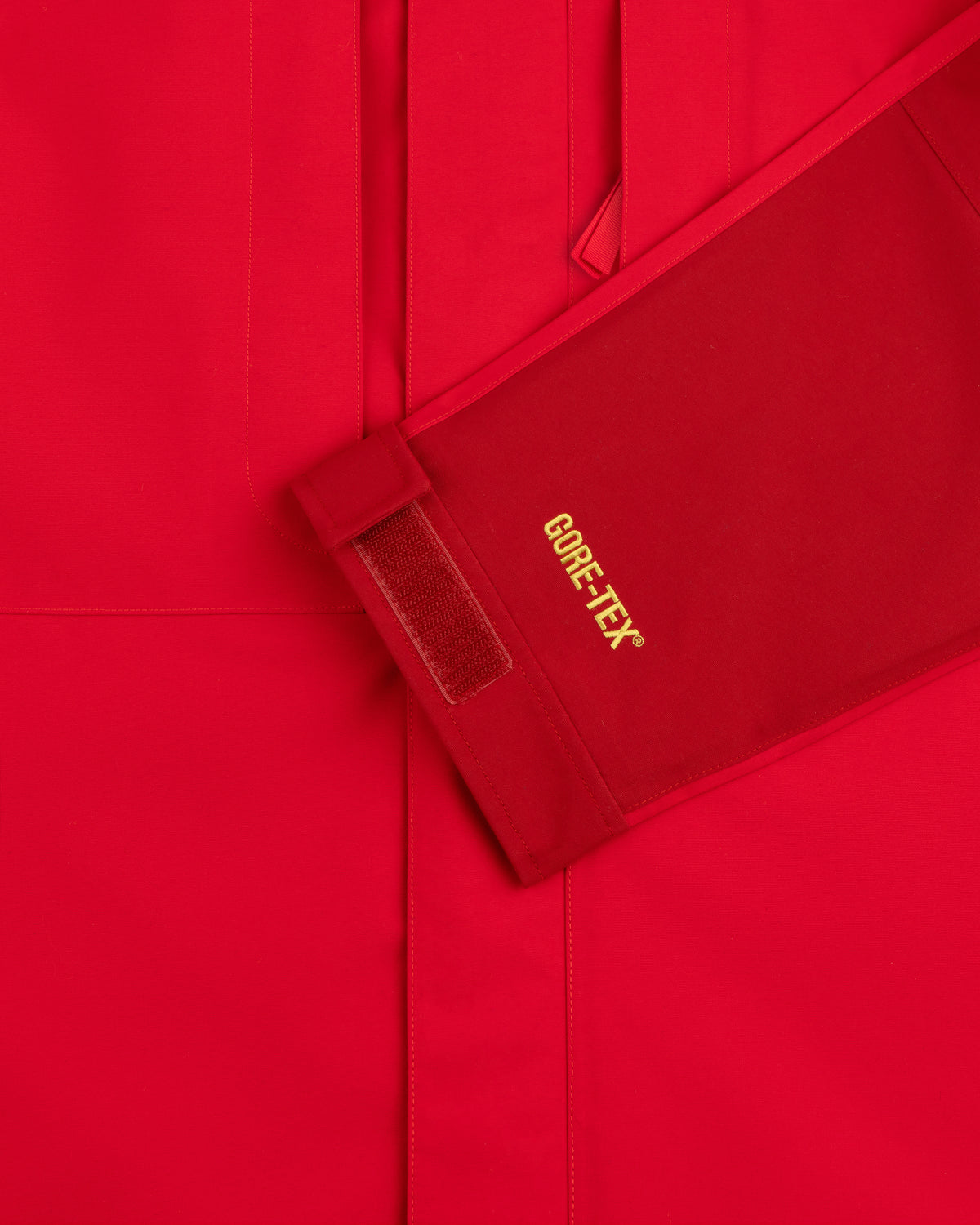 Close-up of ALD/The North Face GORE-TEX 2000 Mountain Jacket sleeve with yellow text and Velcro cuff strap.