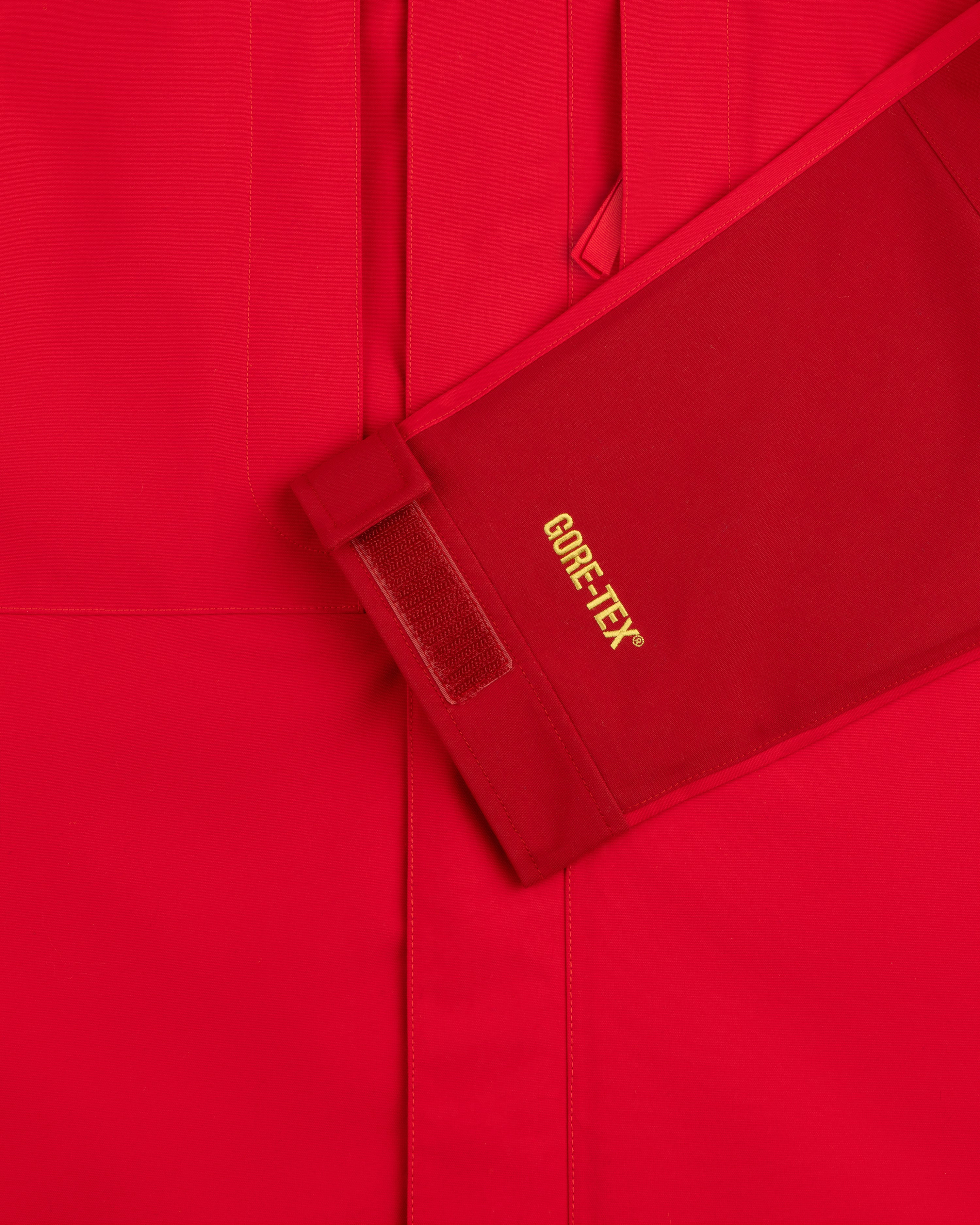 Close-up of ALD/The North Face GORE-TEX 2000 Mountain Jacket sleeve with yellow text and Velcro cuff strap.
