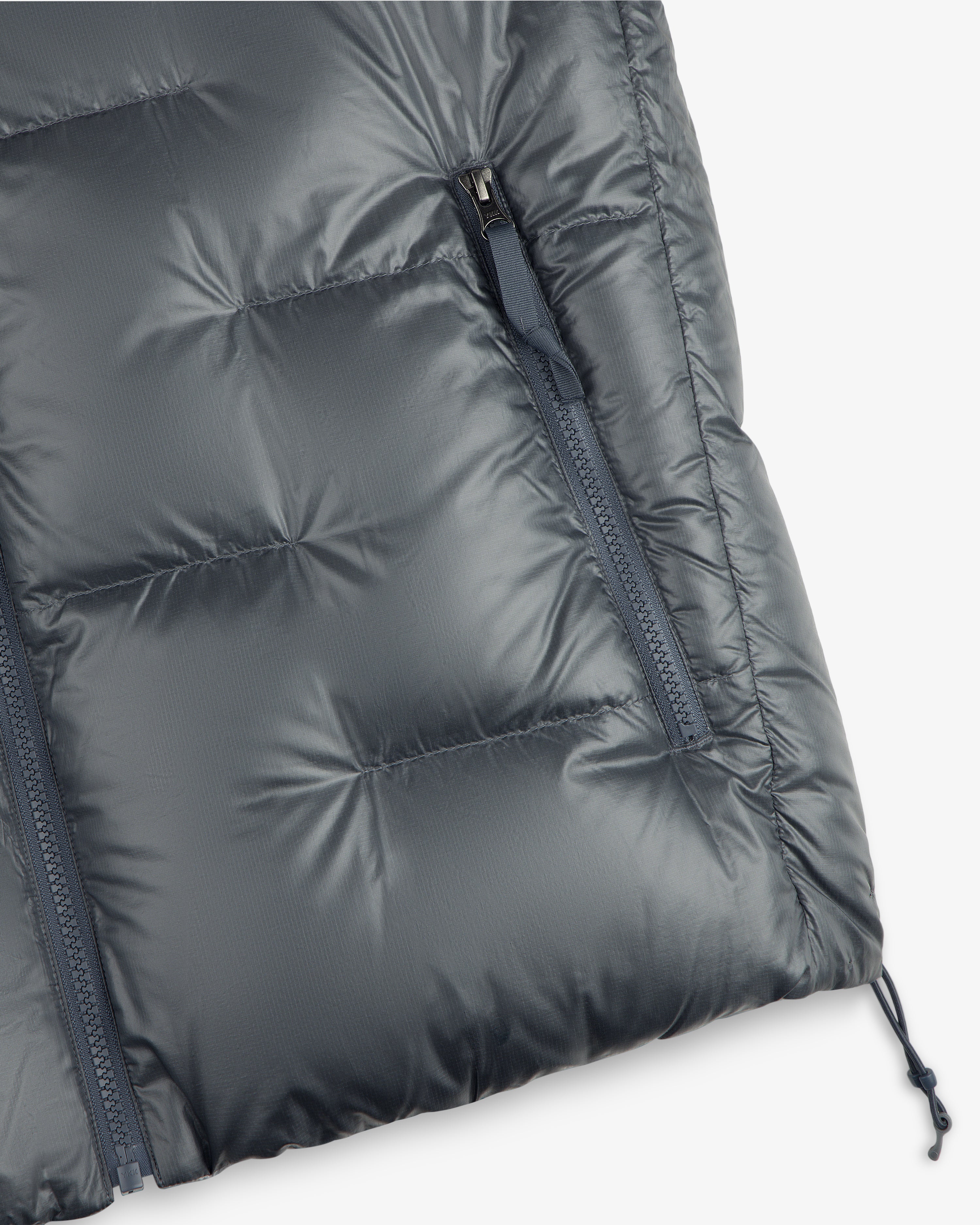Close-up of the ALD / The North Face Reversible Pertex® Nuptse Jacket with zipped pocket and quilted details.