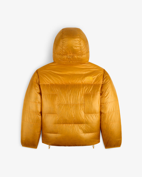 ALD / The North Face Reversible Pertex® Nuptse Jacket in shiny mustard yellow, hooded, back view on white.
