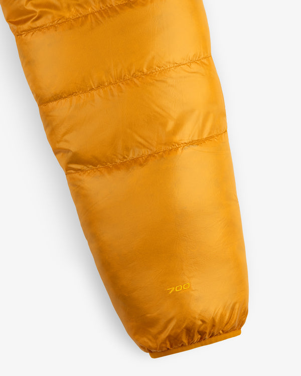 Close-up of ALD / The North Face Reversible Pertex® Nuptse Jacket’s yellow sleeve with “700” stitched near the cuff.