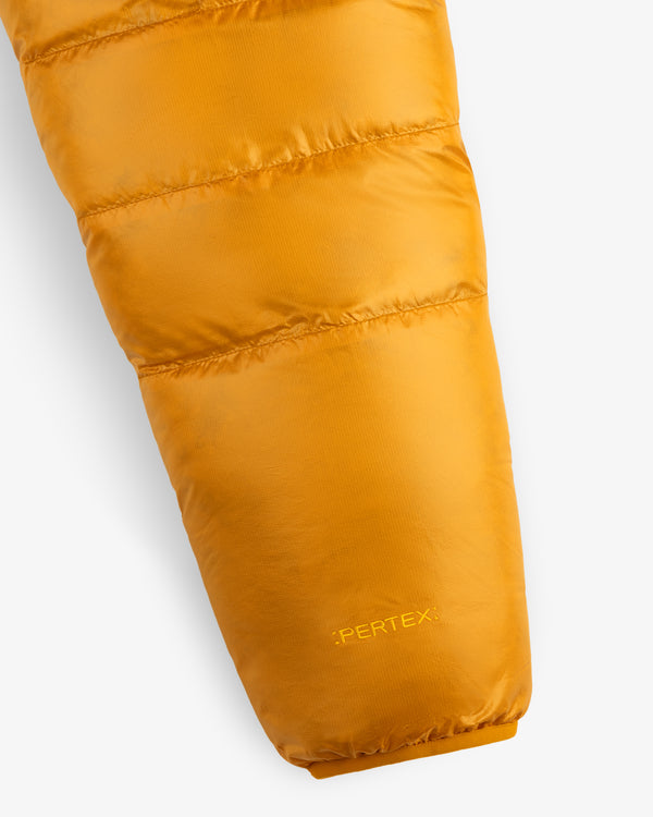 Close-up of ALD/The North Face Reversible Pertex® Nuptse Jacket sleeve with logo on cuff, white background.