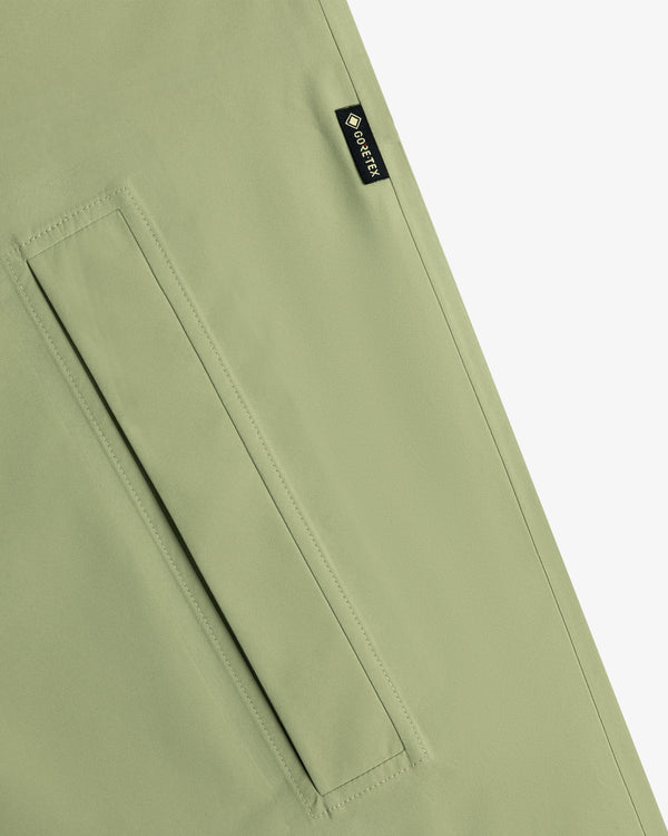 Close-up of the ALD/The North Face GORE-TEX Trench Coat in light green with a rectangular pocket and black GORE-TEX label.