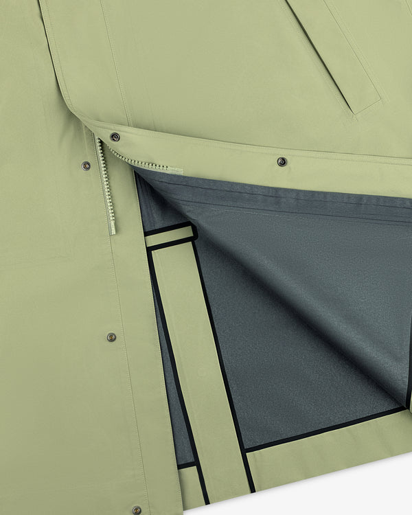 Close-up of the ALD/The North Face GORE-TEX Trench Coat with light green outer, gray lining, and snap button flap.