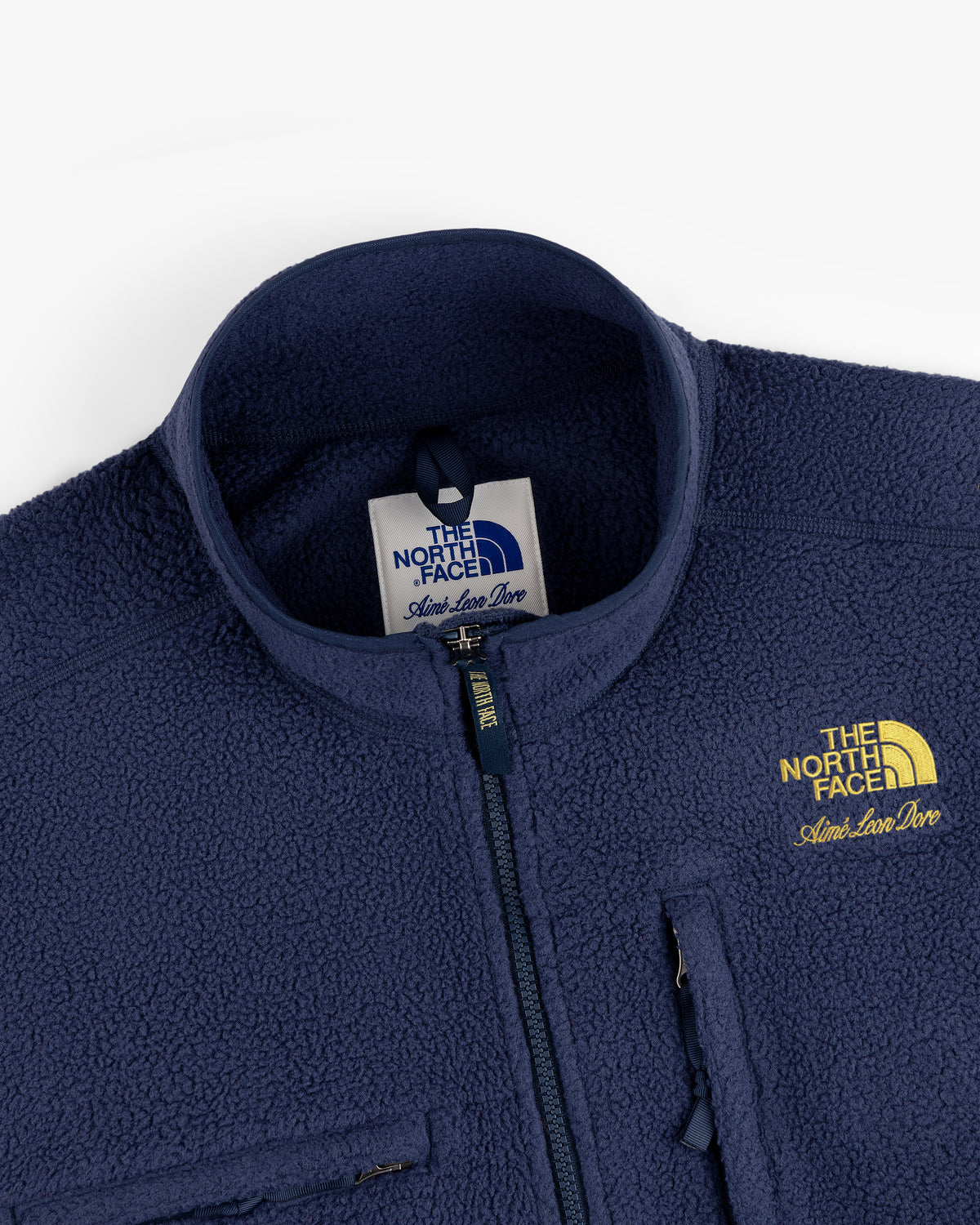 Navy ALD/The North Face ’95 Denali Half-Zip Fleece Pullover with yellow logo, chest pocket, shown from collar.