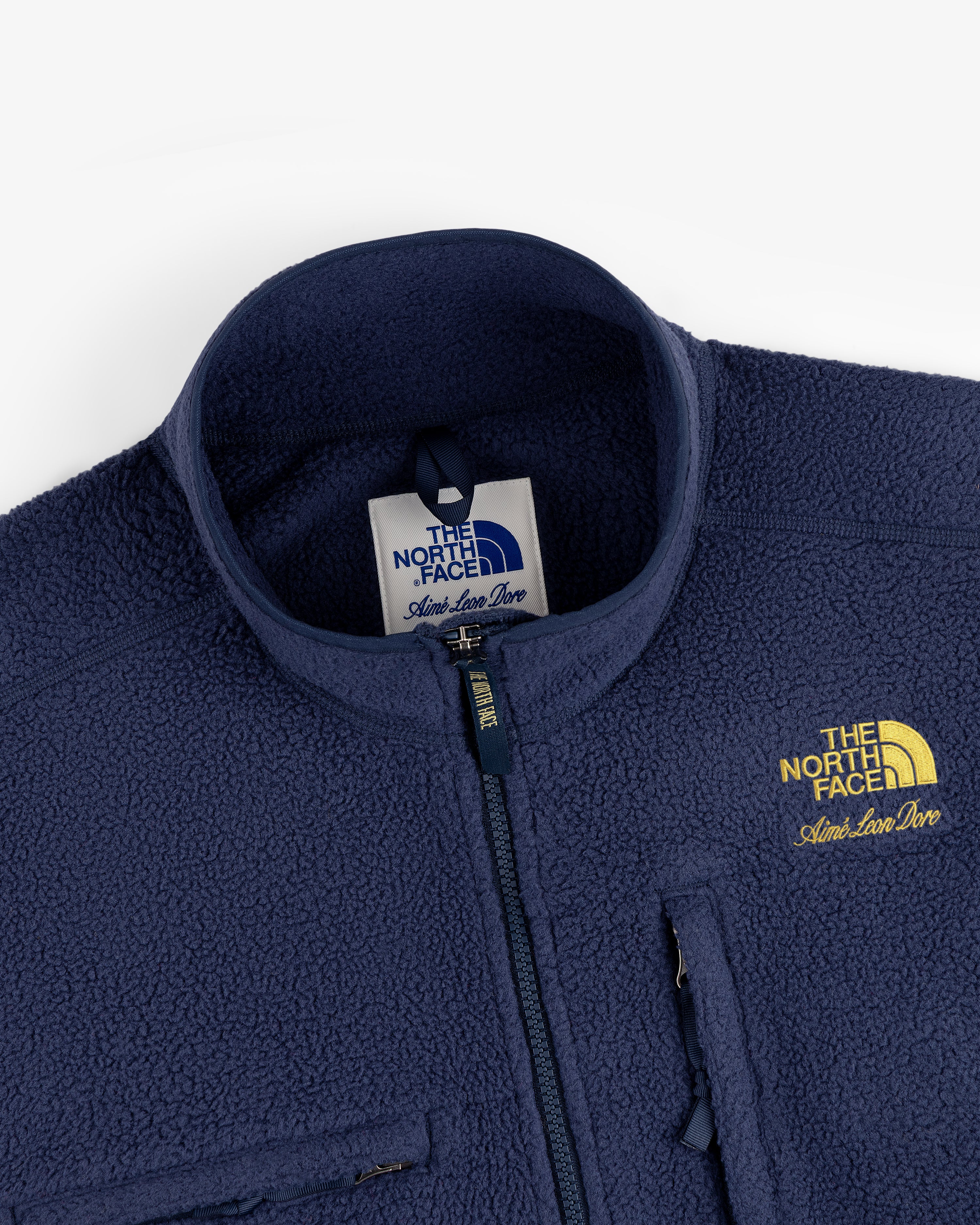 Navy ALD/The North Face ’95 Denali Half-Zip Fleece Pullover with yellow logo, chest pocket, shown from collar.